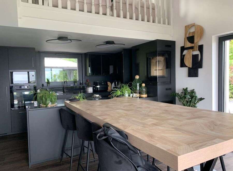 This modern kitchen boasts a stunning wooden island, perfect for both cooking and entertaining.