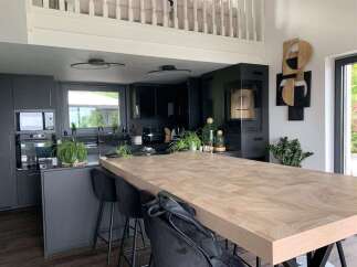This modern kitchen boasts a stunning wooden island, perfect for both cooking and entertaining.