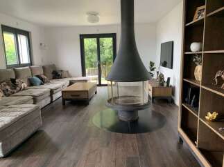 This stunning living room boasts a modern fireplace, creating a cozy ambiance.