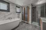 Step into luxury with this stunning bathroom featuring a sleek, modern design.