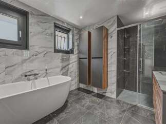 Step into luxury with this stunning bathroom featuring a sleek, modern design.