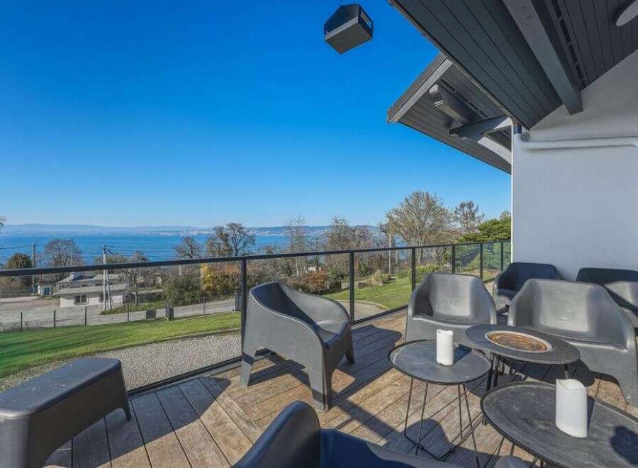 Enjoy breathtaking views from this stunning property! This home features a spacious deck with comfortable seating, perfect for relaxing and entertaining.