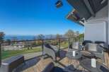 Enjoy breathtaking views from this stunning property! This home features a spacious deck with comfortable seating, perfect for relaxing and entertaining.