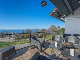Enjoy breathtaking views from this stunning property! This home features a spacious deck with comfortable seating, perfect for relaxing and entertaining.