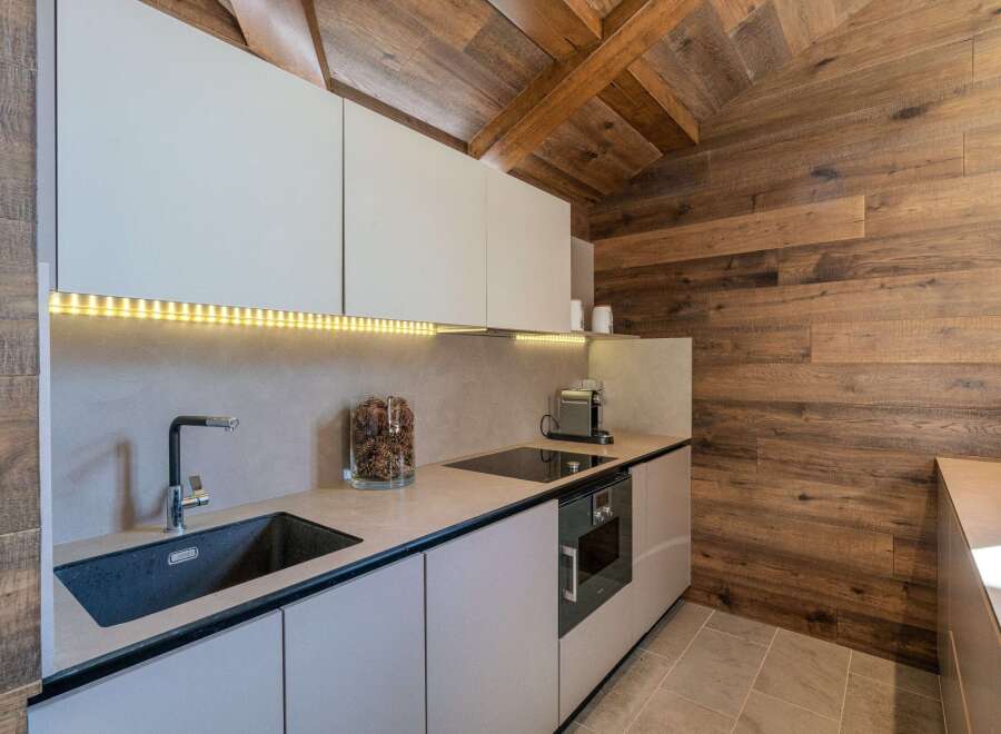 This stunning kitchen features a modern design with sleek cabinetry and a built-in oven.