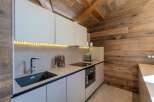 This stunning kitchen features a modern design with sleek cabinetry and a built-in oven.