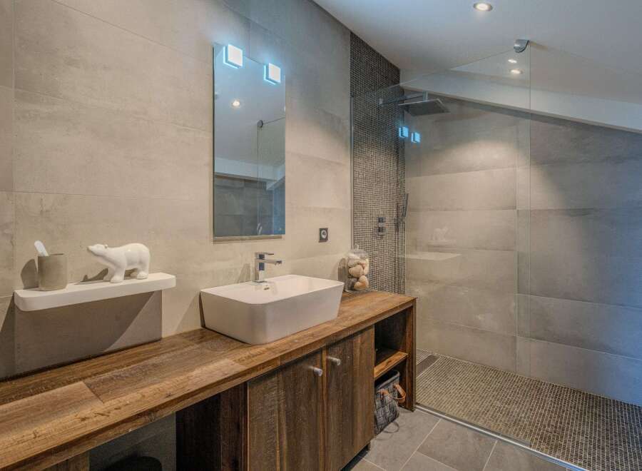Step into luxury with this stunning bathroom, featuring a sleek, modern design.