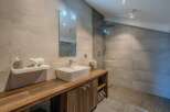 Step into luxury with this stunning bathroom, featuring a sleek, modern design.
