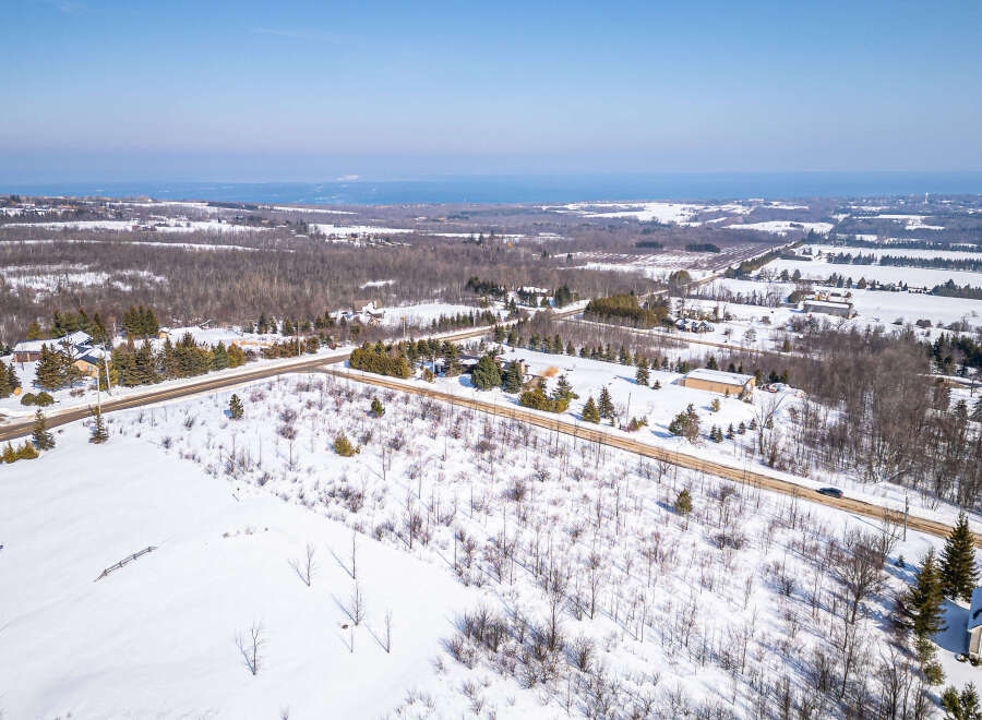This stunning aerial view showcases a beautiful property nestled in a winter wonderland.