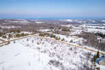 This stunning aerial view showcases a beautiful property nestled in a winter wonderland.