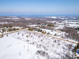 This stunning aerial view showcases a beautiful property nestled in a winter wonderland.