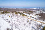 Discover a stunning property nestled in a serene winter landscape.