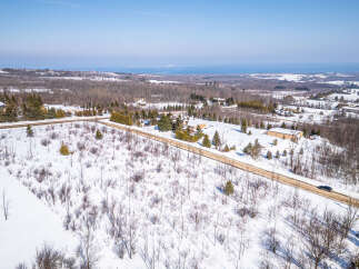 Discover a stunning property nestled in a serene winter landscape.