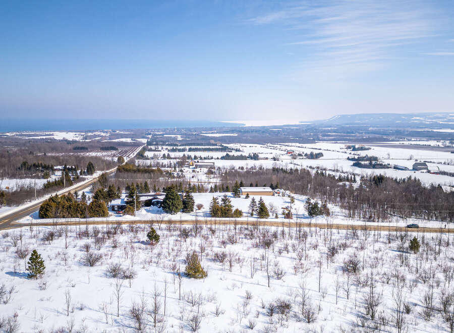 This stunning aerial view showcases a picturesque winter landscape, perfect for those seeking a serene escape.