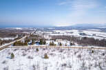 This stunning aerial view showcases a picturesque winter landscape, perfect for those seeking a serene escape.