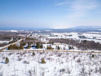 This stunning aerial view showcases a picturesque winter landscape, perfect for those seeking a serene escape.