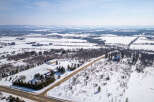This stunning property offers a serene winter landscape, perfect for those seeking a peaceful retreat.