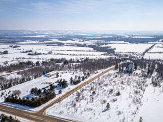 This stunning property offers a serene winter landscape, perfect for those seeking a peaceful retreat.