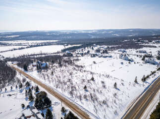 This stunning property offers a serene winter landscape, perfect for those seeking a peaceful retreat.