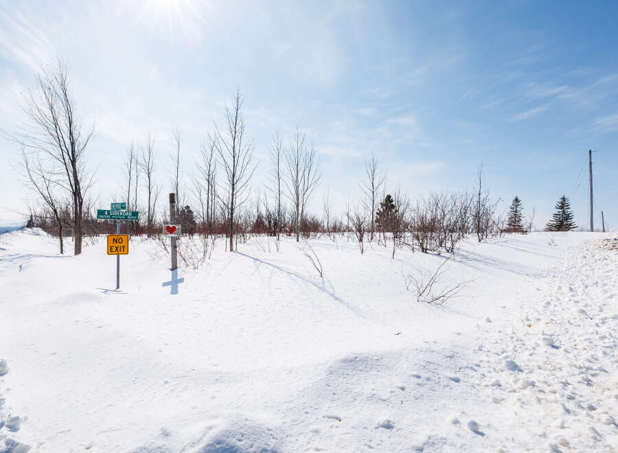 This stunning property offers a serene winter landscape, perfect for those seeking tranquility.