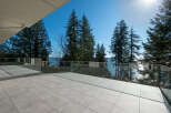 Enjoy breathtaking views from this stunning property! This modern home features a spacious outdoor patio with glass railings, perfect for entertaining or relaxing.