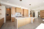 This stunning modern kitchen boasts sleek cabinetry, a spacious island, and high-end appliances.