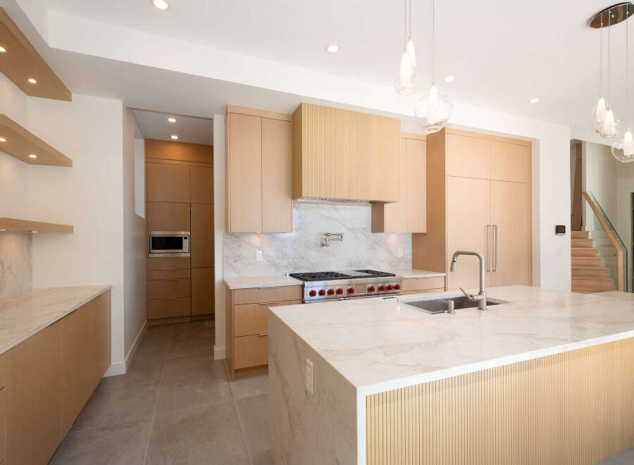 Experience luxury living in this stunning kitchen! Featuring a modern design with sleek cabinetry, a spacious island, and high-end appliances, this space is perfect for both cooking and entertaining.