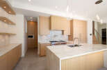 Experience luxury living in this stunning kitchen! Featuring a modern design with sleek cabinetry, a spacious island, and high-end appliances, this space is perfect for both cooking and entertaining.