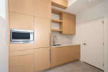 This modern kitchen boasts sleek cabinetry and a built-in microwave, perfect for contemporary living.