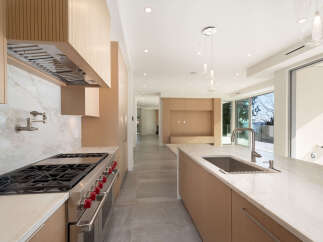 Experience luxury living in this stunning kitchen! Featuring a modern design with sleek cabinetry, a spacious island, and top-of-the-line appliances, this kitchen is perfect for both cooking and entertaining.