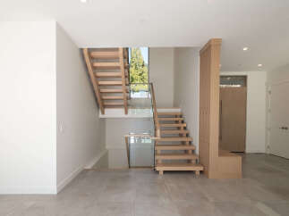 This stunning property boasts a modern staircase design, creating a focal point in the entryway.