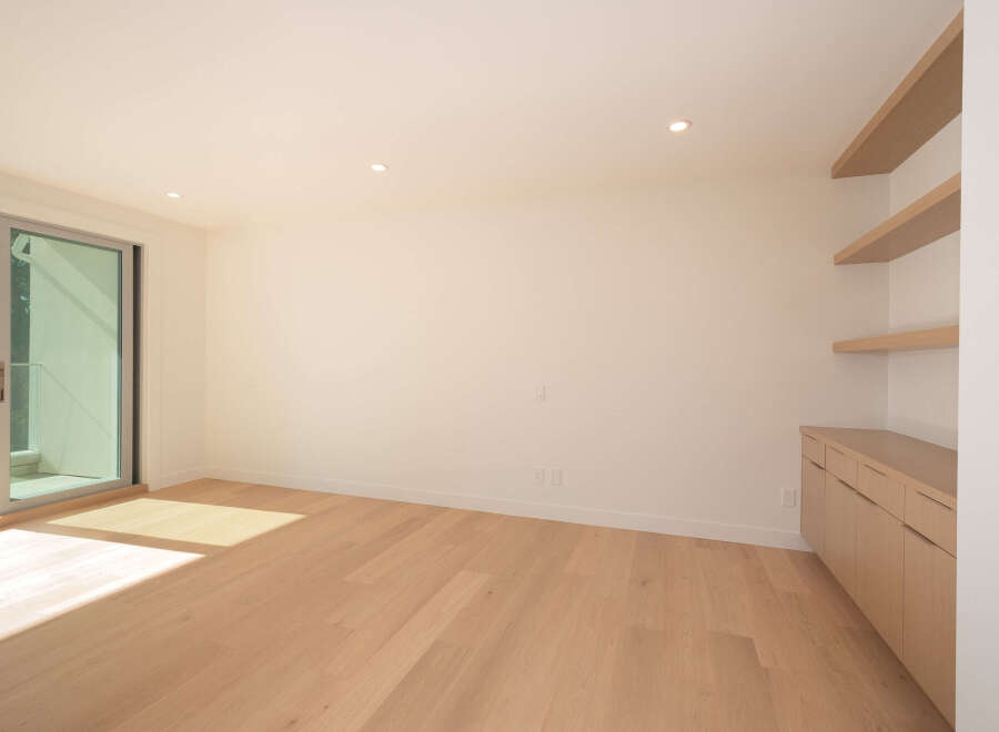 Step into this bright and airy modern living space, featuring beautiful hardwood floors and ample natural light.