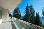 Enjoy breathtaking views from this stunning balcony overlooking the ocean and lush greenery.