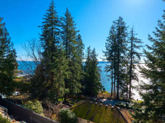 Enjoy breathtaking views from this stunning property, featuring lush greenery and a serene waterfront setting.