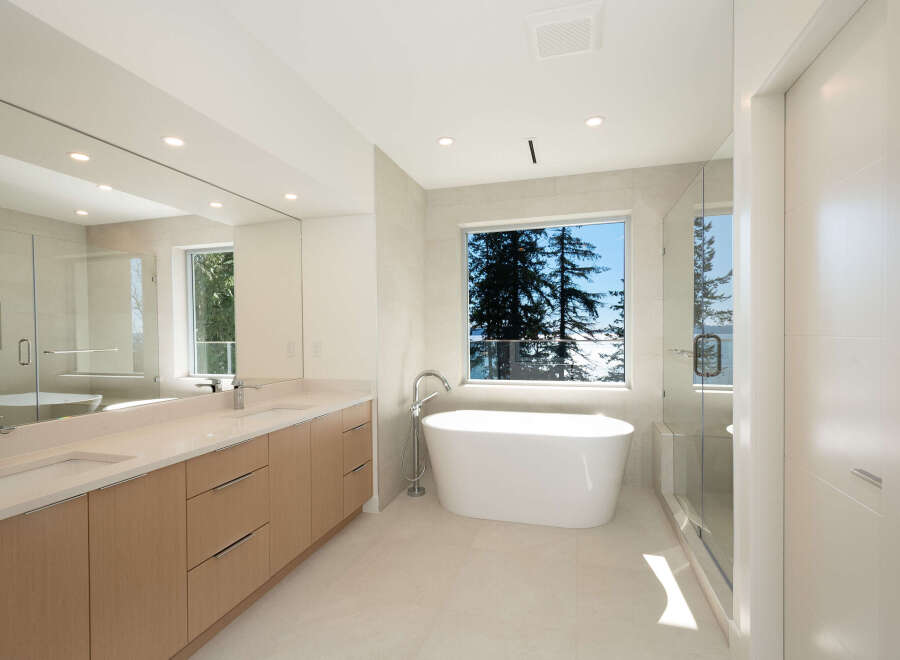 This luxurious bathroom boasts a modern design with a freestanding tub, perfect for relaxation.