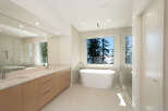 This luxurious bathroom boasts a modern design with a freestanding tub, perfect for relaxation.