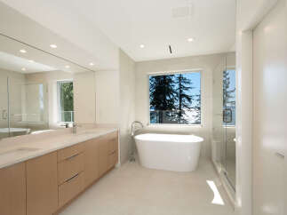 This luxurious bathroom boasts a modern design with a freestanding tub, perfect for relaxation.