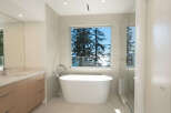 Experience luxury in this stunning bathroom featuring a modern freestanding tub and a spacious glass shower.