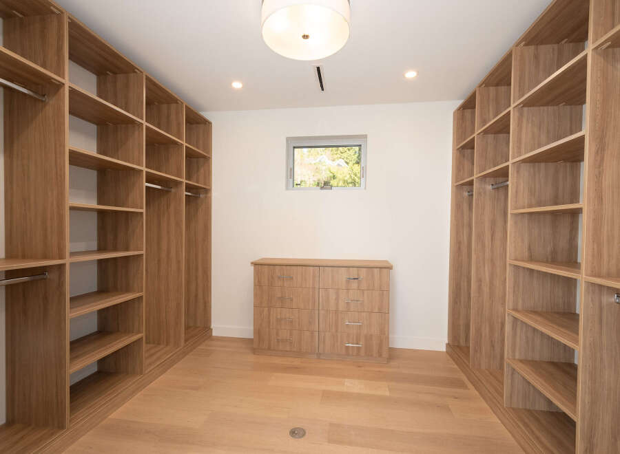 Step into luxury with this stunning walk-in closet, designed for both style and functionality.
