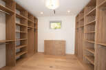 Step into luxury with this stunning walk-in closet, designed for both style and functionality.