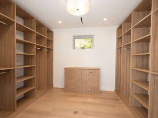 Step into luxury with this stunning walk-in closet, designed for both style and functionality.