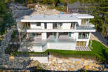 This stunning modern home offers luxurious living with its sleek design and expansive glass windows.