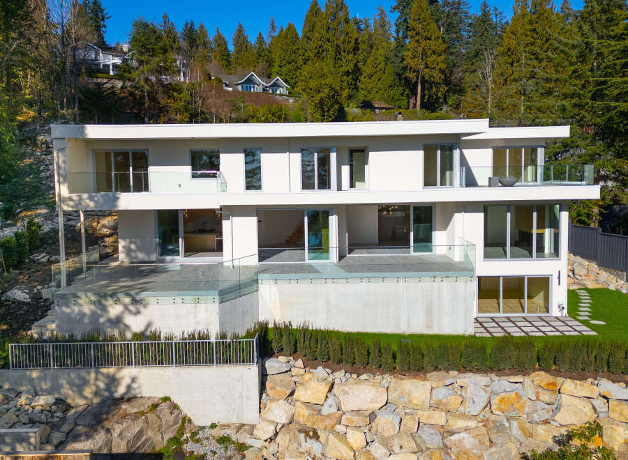 This stunning modern home boasts a sleek design and breathtaking views.