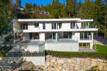 This stunning modern home boasts a sleek design and breathtaking views.
