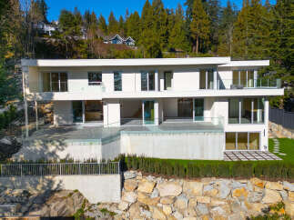 This stunning modern home boasts a sleek design and breathtaking views.