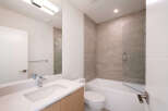 Step into this modern bathroom, featuring a sleek vanity with a pristine white countertop and a stylish faucet.