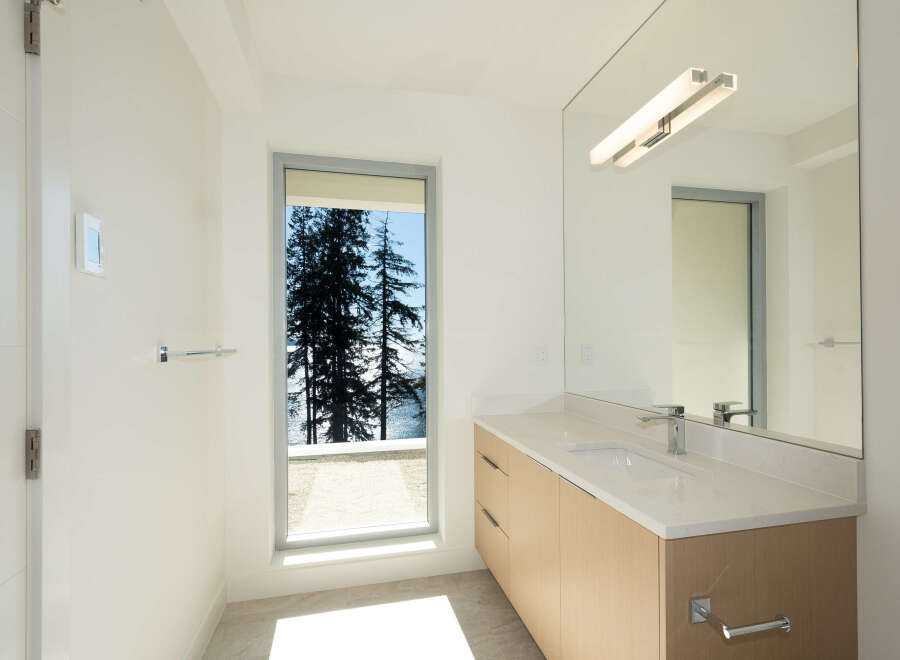 This stunning bathroom boasts a modern design with a serene view.
