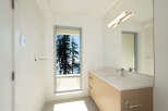 This stunning bathroom boasts a modern design with a serene view.