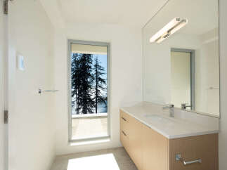 This stunning bathroom boasts a modern design with a serene view.
