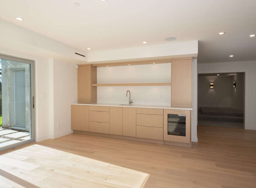 This stunning property boasts a modern wet bar, perfect for entertaining guests.